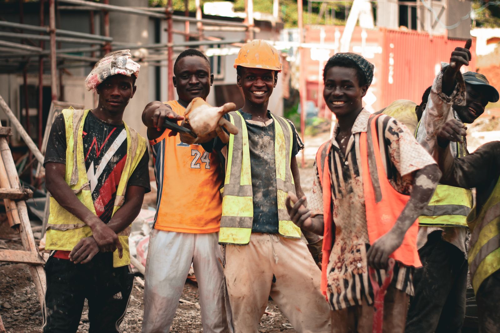 A smiling work crew in hard hats and high-visibility vests